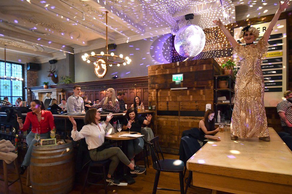 People enjoy a live show at a bar in Manchester on 17 May, following the easing of lockdown restrictions