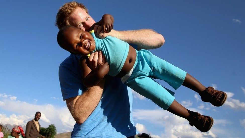 Prince Harry playing with a child in Lesotho