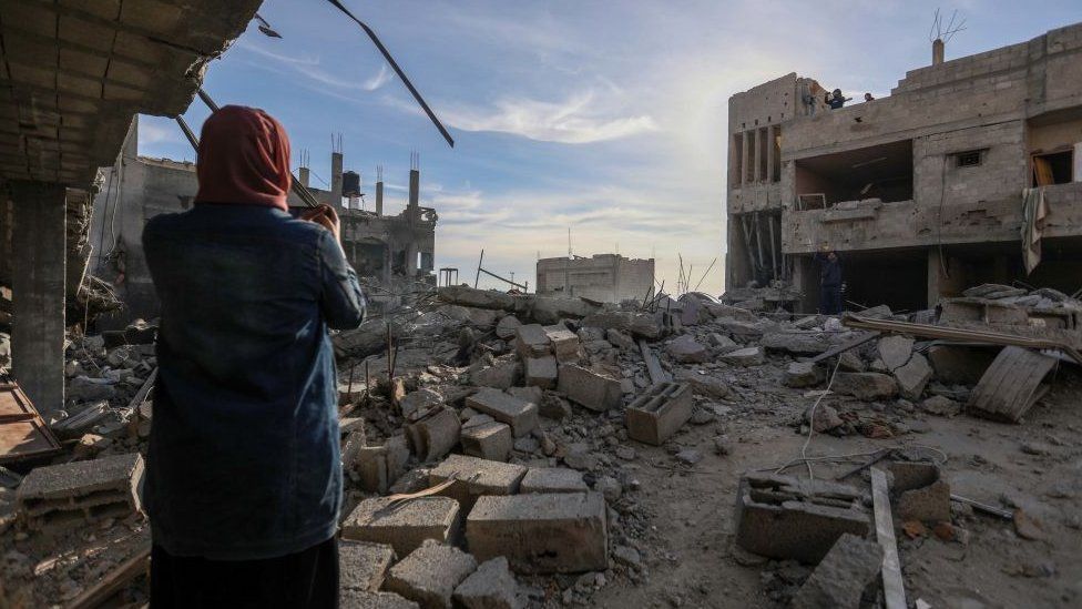 A woman views damage following Israeli air strikes on February 12, 2024 in Rafah