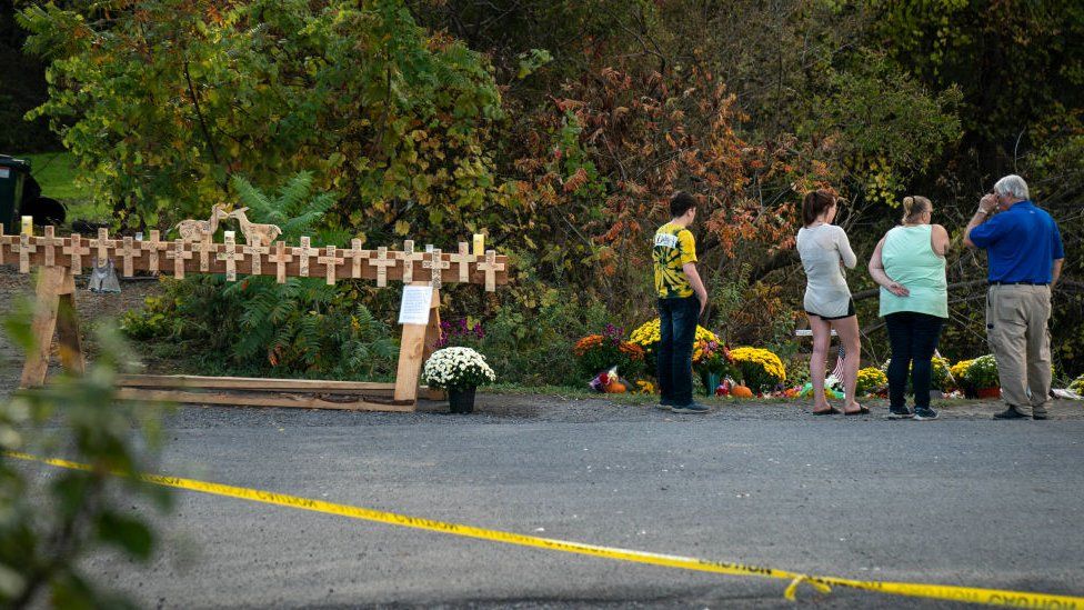 Image shows a vigil at the site of the crash