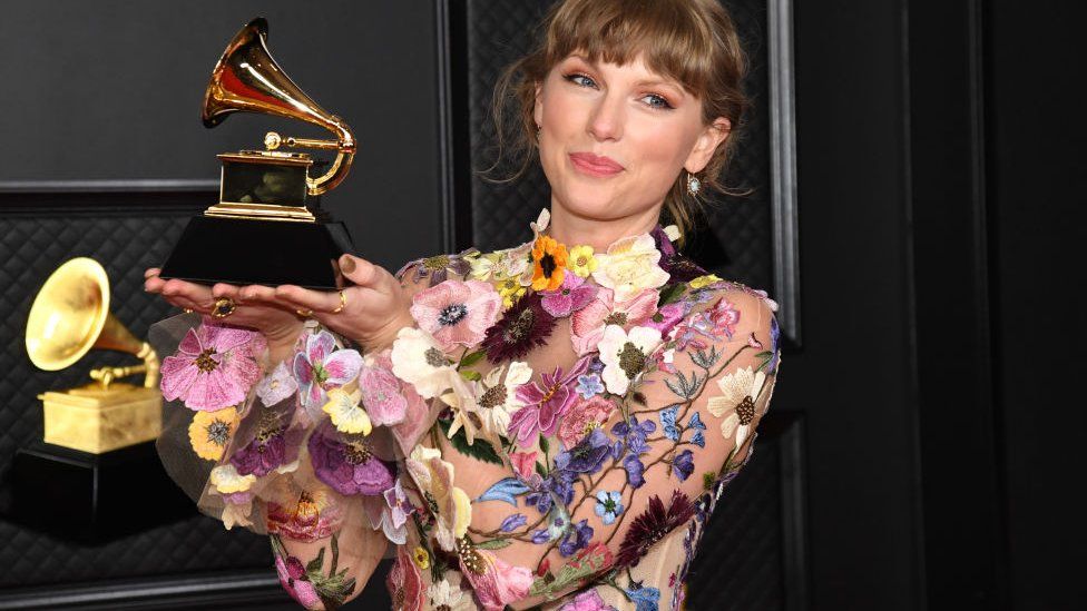 Taylor Swift with her Grammy for album of the year, at the Grammy Awards at the Los Angeles Convention Center on March 14, 2021