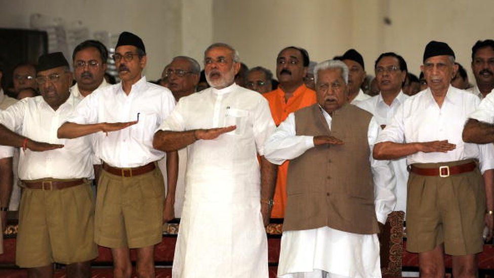 Chief Minister Narendra Modi (3rd L) and former chief minister Keshubhai Patel (2nd R, front) gesture as they attend a Rashtriya Swayamsevak Sangh (RSS) gathering at the Tria Mandir in Adalaj, some 20 kms from Ahmedabad on September 6, 2009.