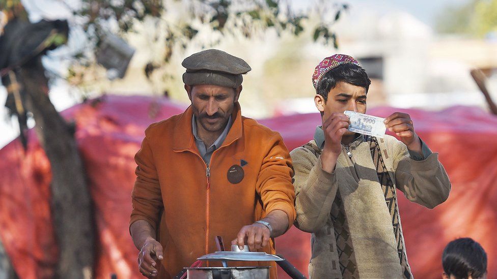 Men cook tea at a roadside stall in Pakistan