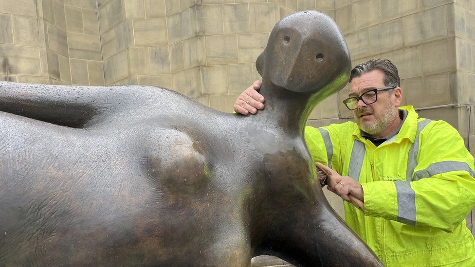 The Henry Moore sculpture being cleaned