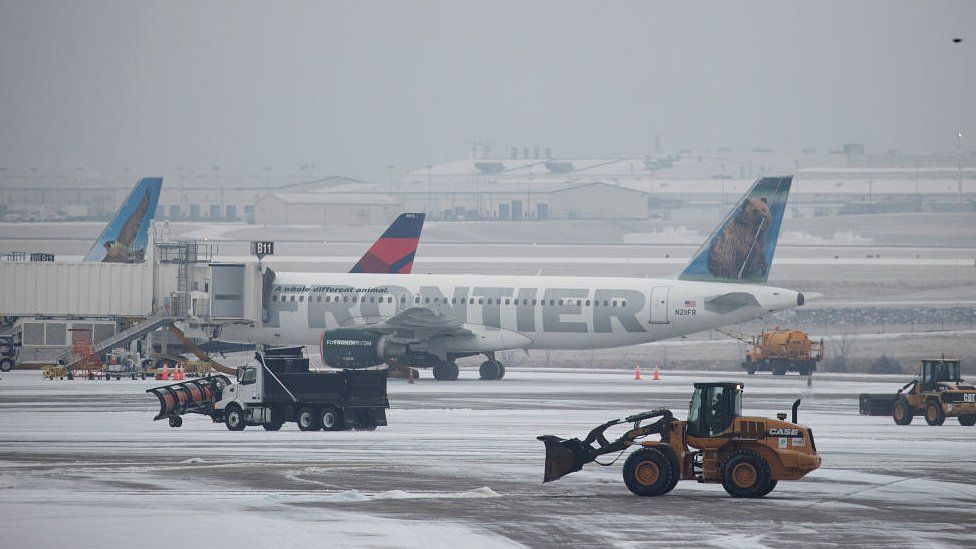 Snow removal vehicles clear ice from around planes at Nashville International Airport on February 15, 2021 in Nashville, Tennessee