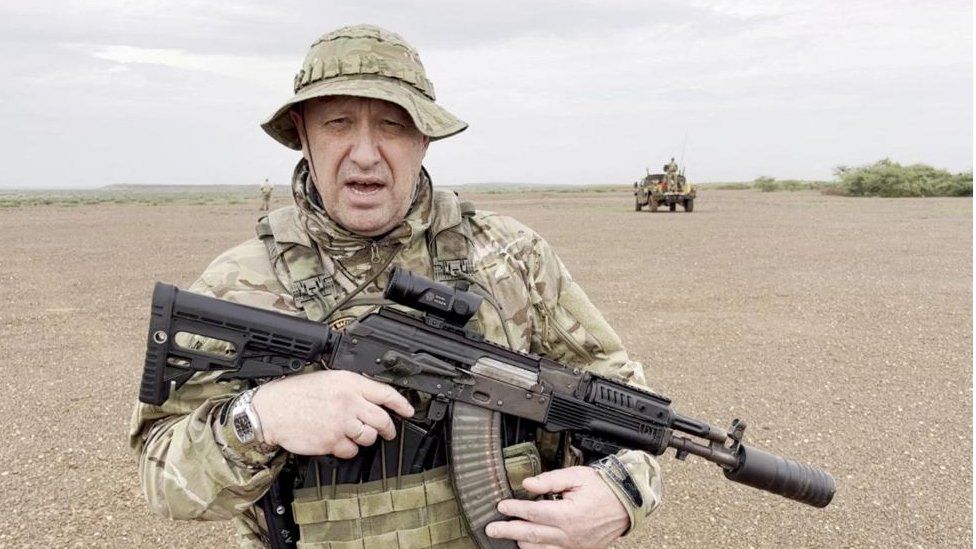 Yevgeny Prigozhin gives an address dressed in camouflage and holding a weapon in a location thought to be Mali.