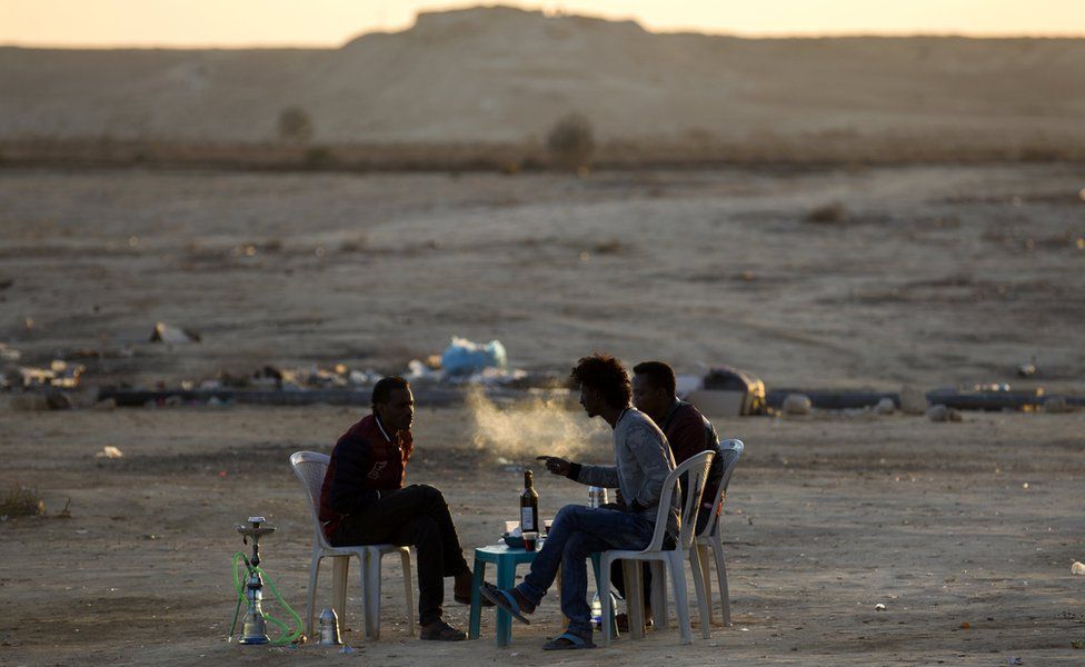 Eritrean refugees smoke water pipes outside the Holot detention facility in Israel - Wednesday 3 January 2018