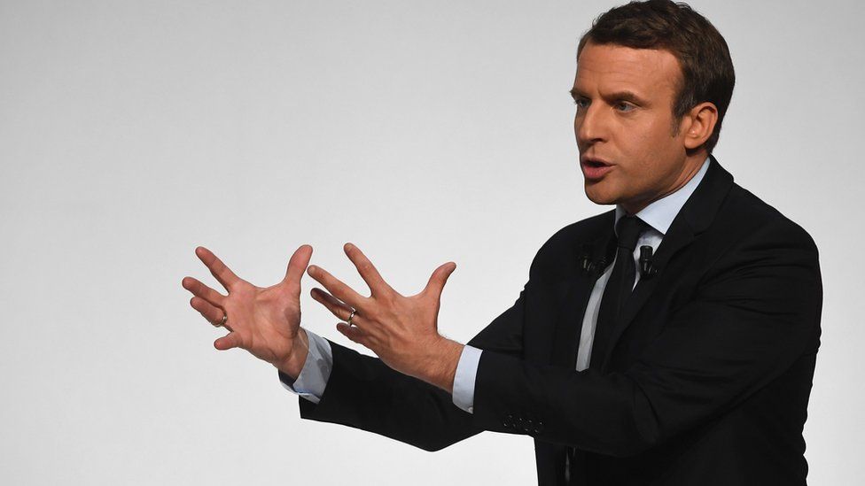 French presidential election candidate for the En Marche ! movement Emmanuel Macron gestures as he speaks to supporters at the Angerlarde hall in Chatellerault, western France on April 28, 2017.