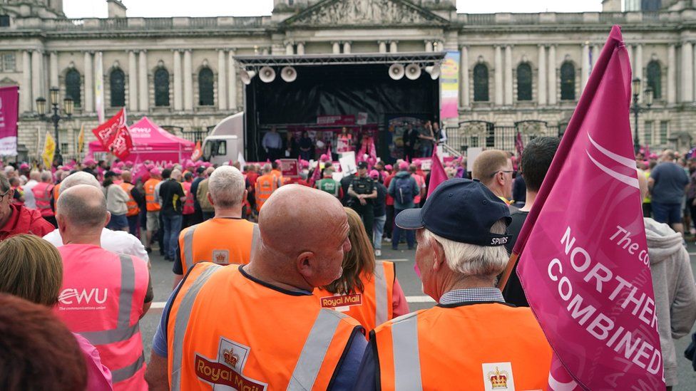 Members of the Communication Workers Union (CWU) demonstrate during a strike outside Belfast Town Hall