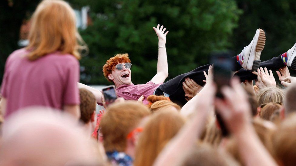 Peet Montzingo is crowd surfed by redheads at the festival