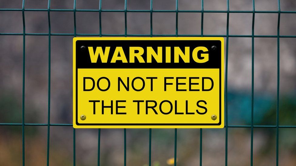 A sign warning to "not feed the trolls"