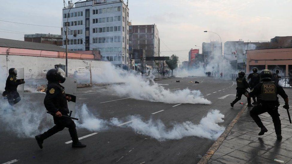 Riot police officers operate during a protest in Lima