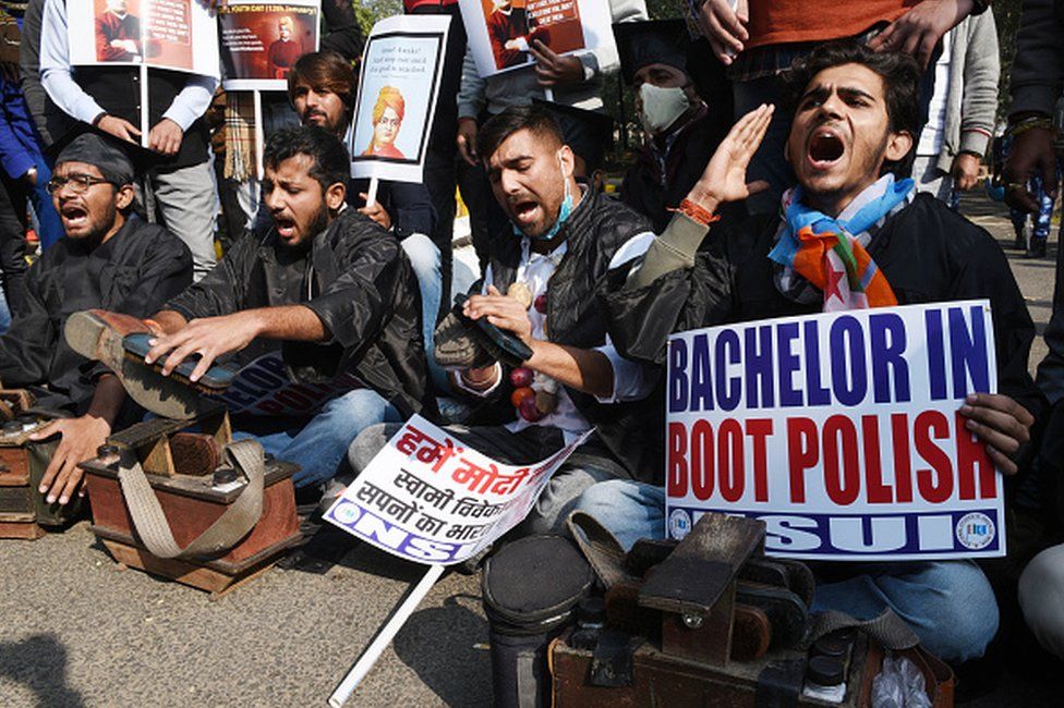 NSUI activists protesting against unemployment by shining shoes at Shastri Bhawan, on January 12, 2021 in New Delhi, India.