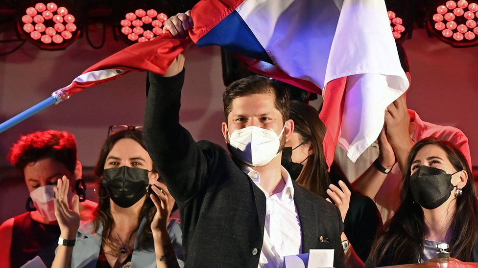 Chilean presidential candidate Gabriel Boric, from the Apruebo Dignidad party, greets supporters in Providencia, Santiago on November 21, 2021, following the first results of the general election.