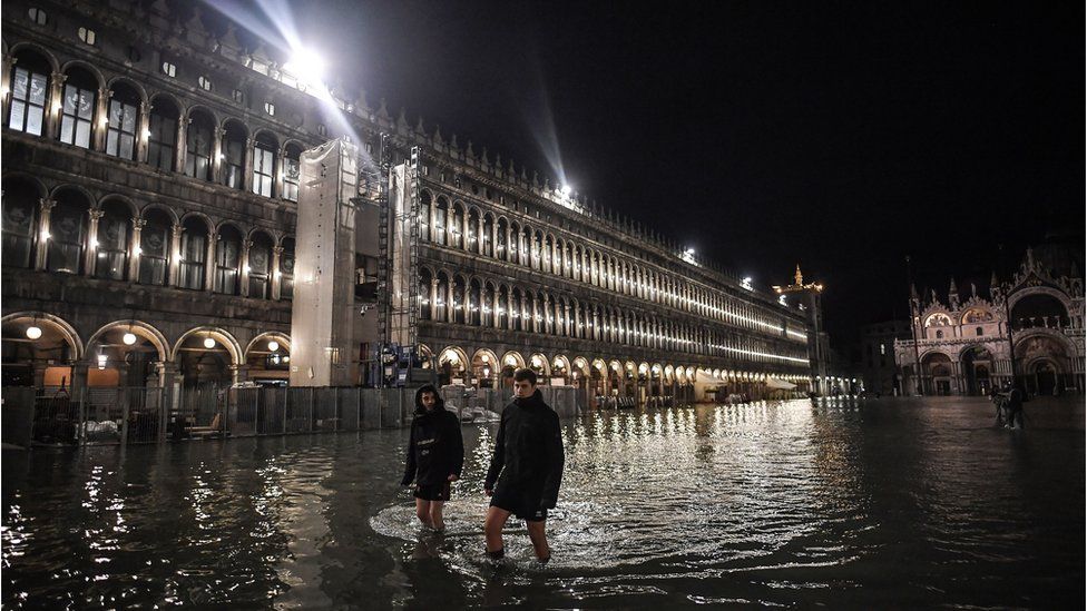 Les gens pataugent dans l'eau sur la place Saint-Marc