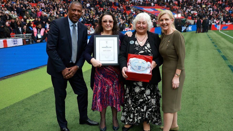 Grandchildren of Jack Leslie accepting honorary cap from FA Chair Debbie Hewitt MBE and former England international Viv Anderson