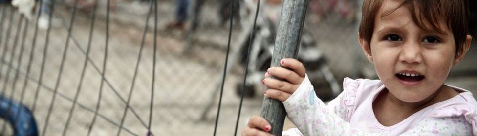 A child plays in the camp at the arrivals area of the old Athens airport on 13 June 2016.