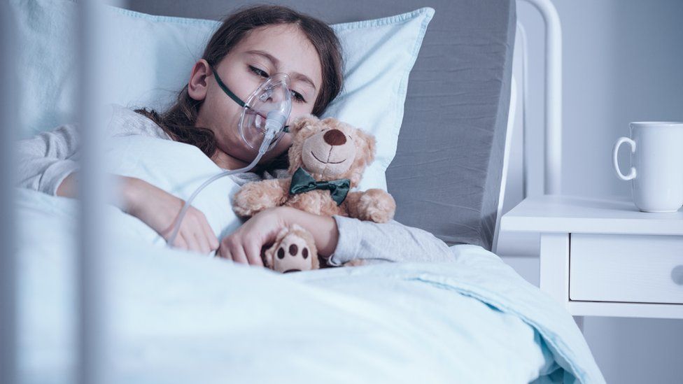 Child with cystic fibrosis in a hospital bed