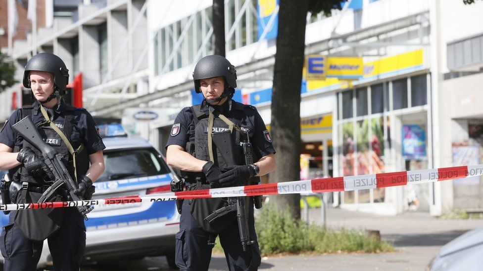 Police cordon off the area around a supermarket in the northern German city of Hamburg, where a man killed one person - 28 July 2017