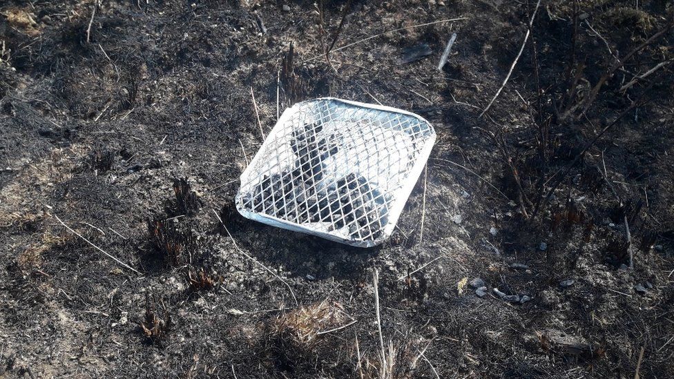 Disposable barbecue on burnt land