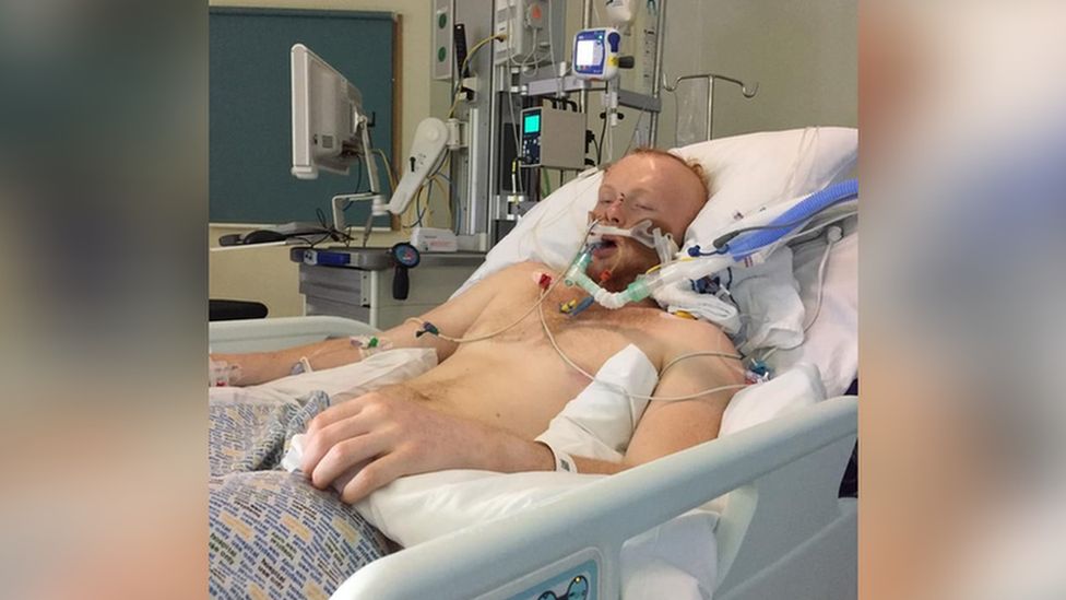 man lying in hospital bed