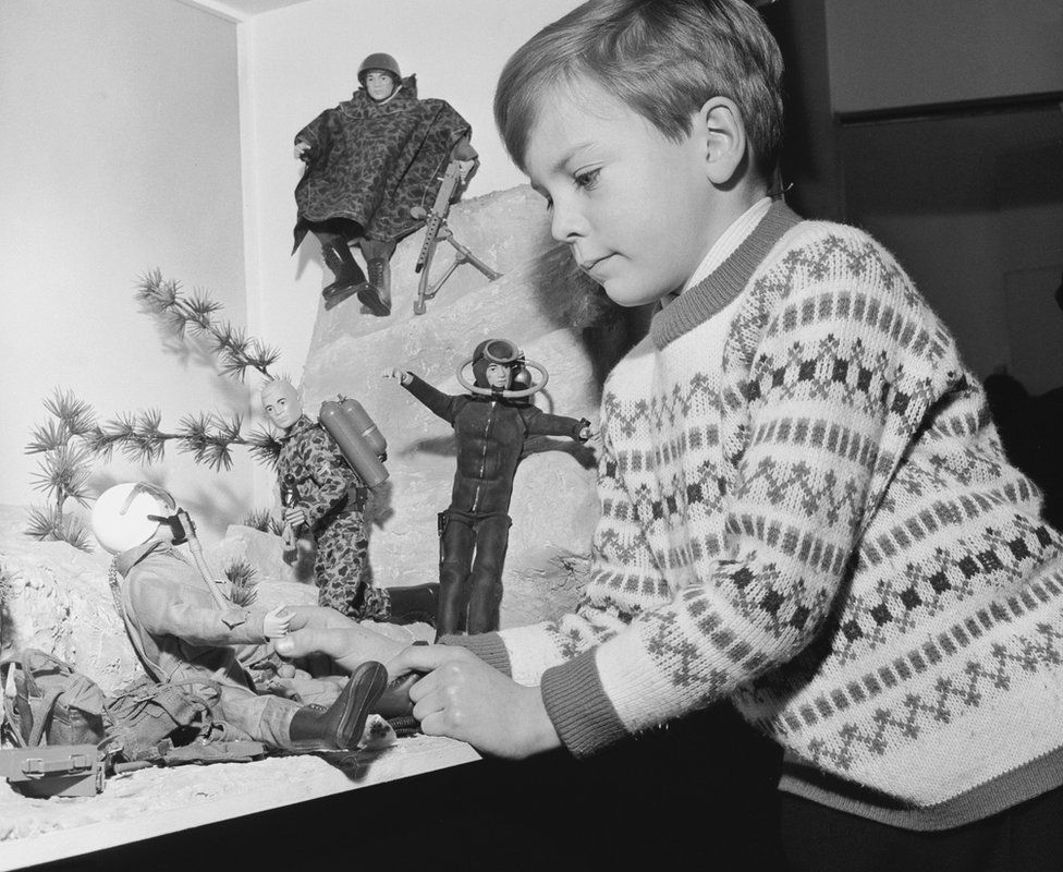 A boy examines a display of Action Man toys at the British Toy Fair in Brighton, January 1966