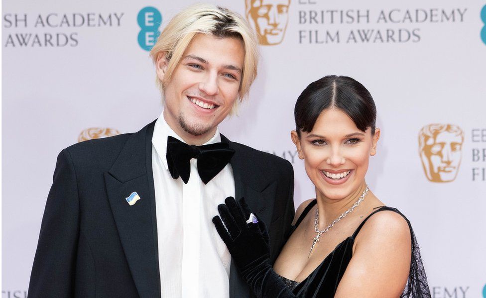 Jake Bongiovi and Millie Bobby Brown attend the EE British Academy Film Awards 2022 at Royal Albert Hall on March 13, 2022 in London, England.