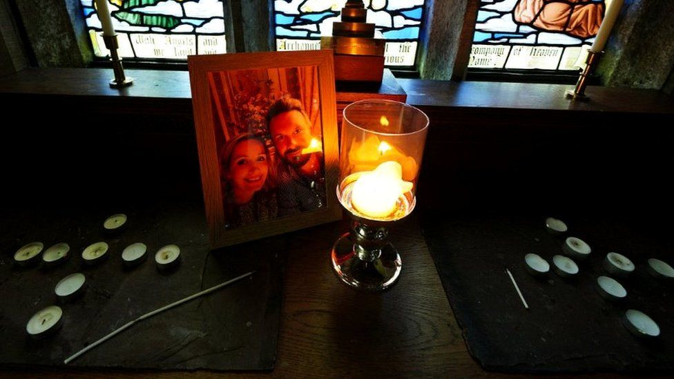 A candle is lit in front of a photo of Nicola Bulley (left) and her partner Paul Ansell on an altar at St Michael's Church in St Michael's on Wyre