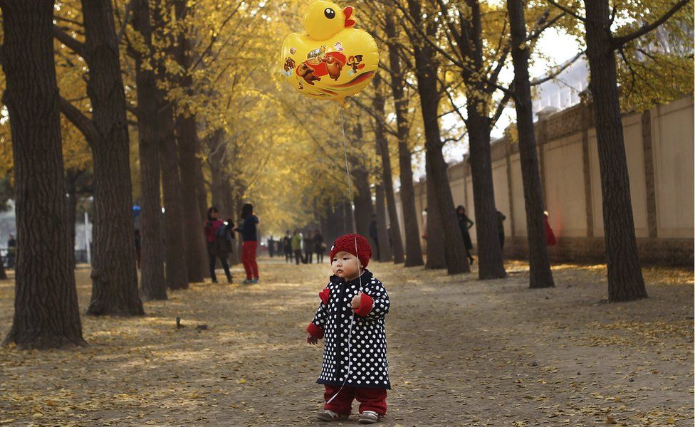 A child holds a balloon in Beijing (Nov 2013)