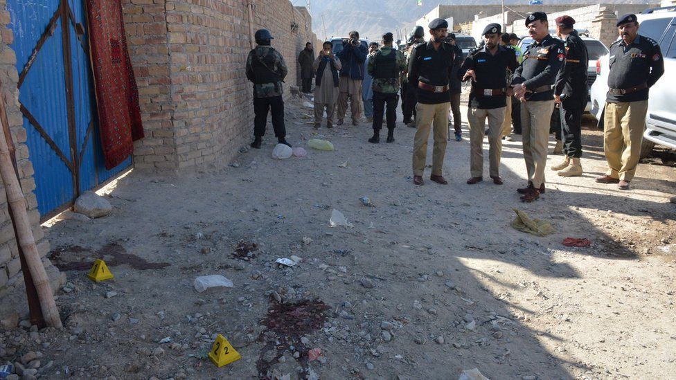 Pakistani police officials gather at the site of an attack by gunmen on a polio vaccination team on the outskirts of Quetta on January 18, 2018