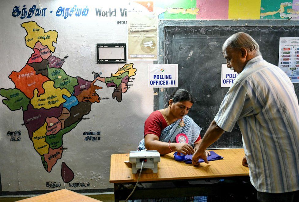 A man (R) has his finger marked with ink after casting his vote at a polling station as voting starts during the first phase of India's general election in Chennai, capital of India's Tamil Nadu state on April 19, 2024.