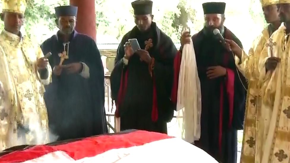Priests around the coffin of Hachalu Hundessa