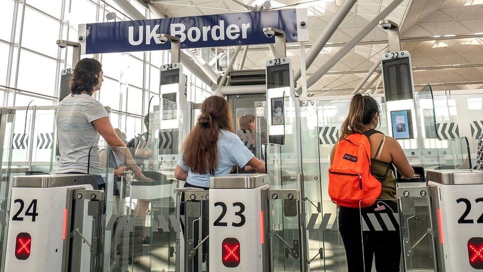 Passengers using the ePassport gates at UK border control, Stansted Airport