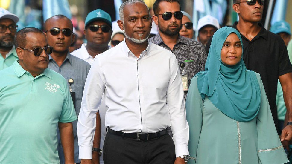 Maldives' President Mohamed Muizzu (centre, in white) along with his supporters take part in an election campaign rally on the eve of the country's parliamentary election