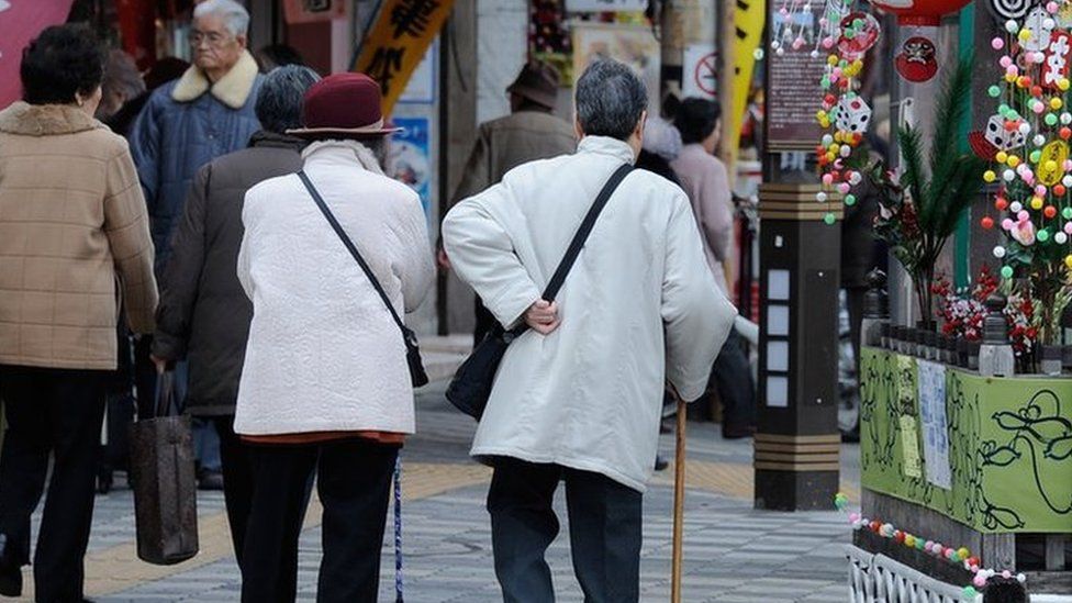 Elderly people walking in a street in Tokyo