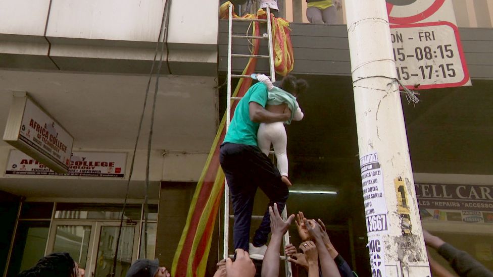 People in Durban being rescued from a building set on fire by looters - Tuesday 13 July 2021