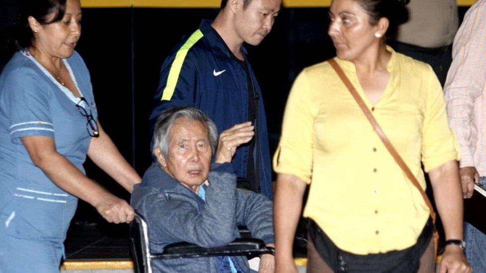 Former Peruvian President Alberto Fujimori accompanied by his son Kenji Fujimori leaves Centenario hospital in Lima, 4 January 2018