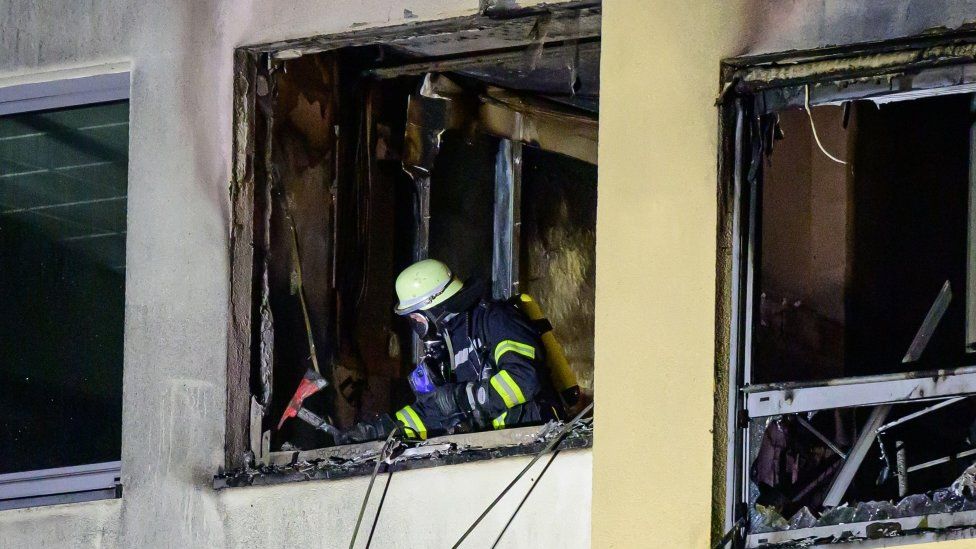 A volunteer firefighter works at the fire in the hospital near Hamburg