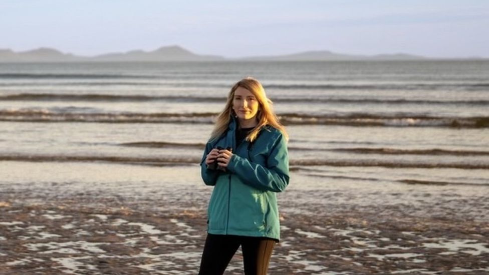 Dani Robertson on a beach in Isle of Anglesey