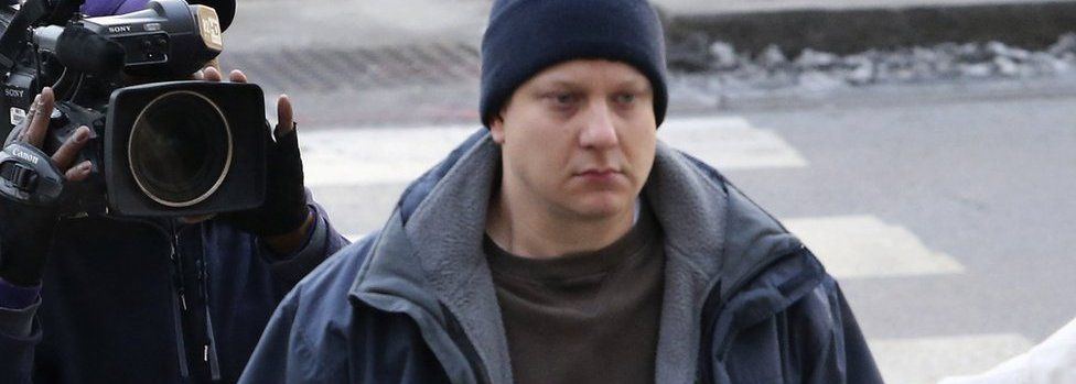 The officer who shot the black teenager, Jason Van Dyke, pictured above, turned himself in