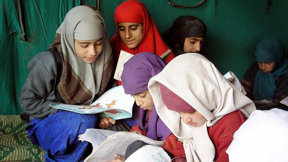 Muslim girls study inside a makeshift school in a tent in the village of Charunda, 8 November, 2005