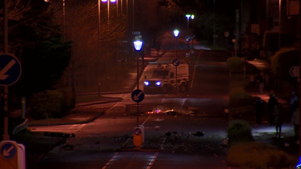 A police Land Rover close to a burning road block in Coleraine