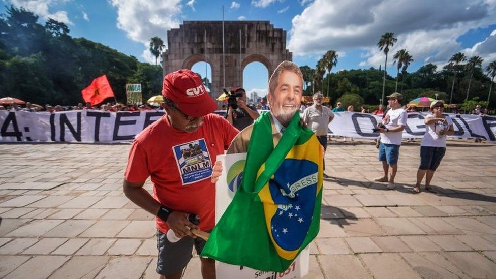 People take part in a demonstration in defence of democracy and the right of former president Luiz Inacio Lula da Silva (PT) to be a candidate in the next national elections, in Porto Alegre in southern Brazil on January 13, 2018.