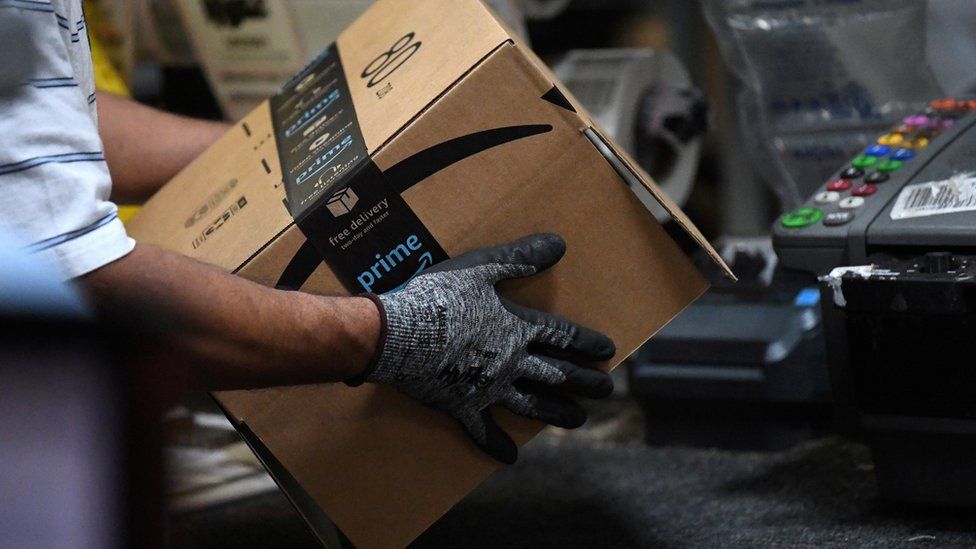 Worker assembles a box for delivery at the Amazon fulfilment centre in Baltimore, Maryland