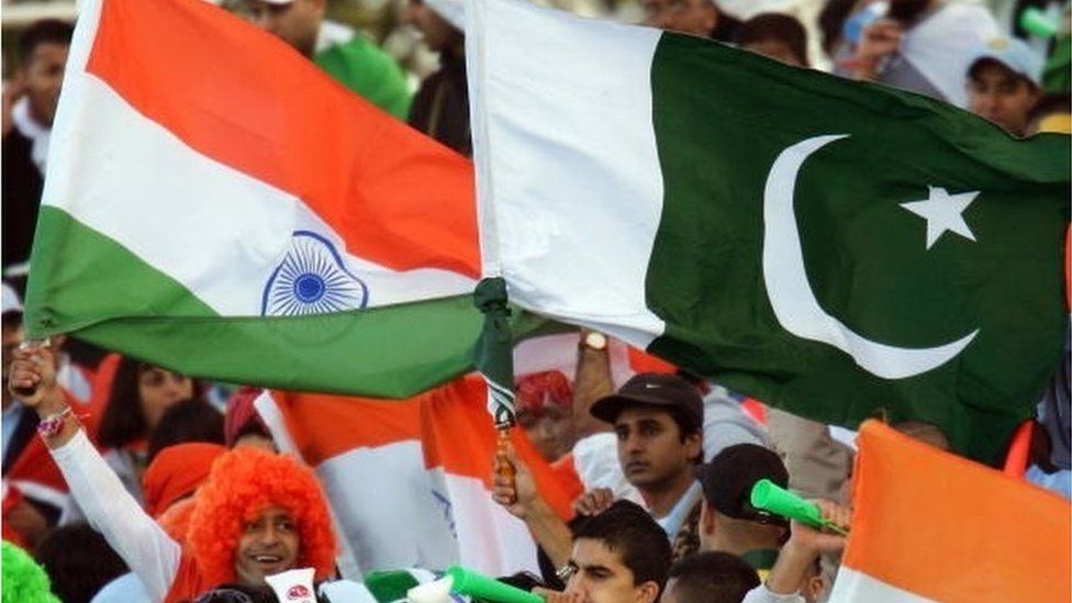 Indian and Pakistani cricket fans celebrate during the ICC Champions Trophy match between Pakistan and India on September 19, 2004 at Edgbaston in Birmingham, England