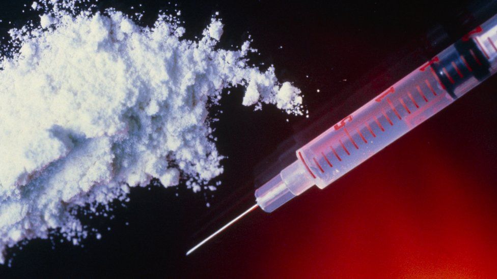 Heroin powder and syringe - file pic