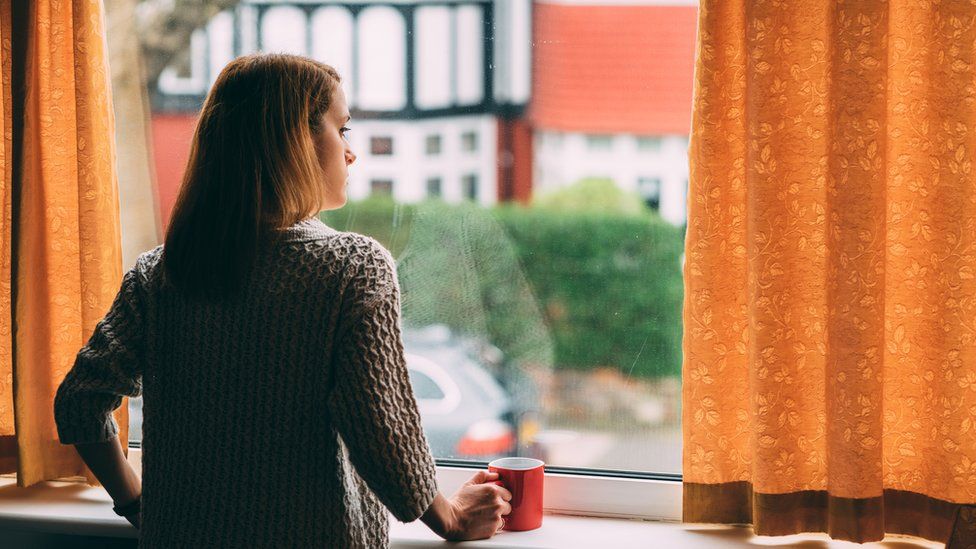 Woman staring out of a window