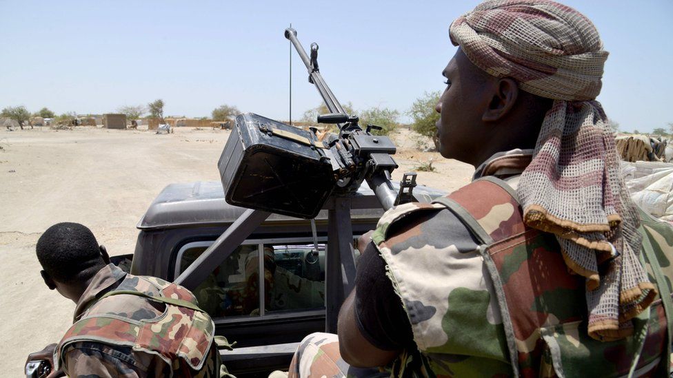 This file photo taken on May 25, 2015 shows Nigerian soldiers patrolling on a road between Diffa and Bosso.
