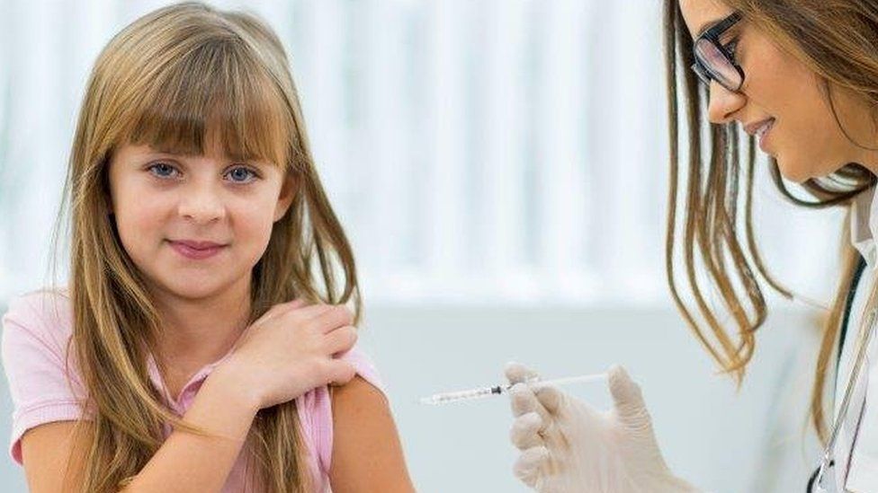 Girl getting vaccine or insulin shot.