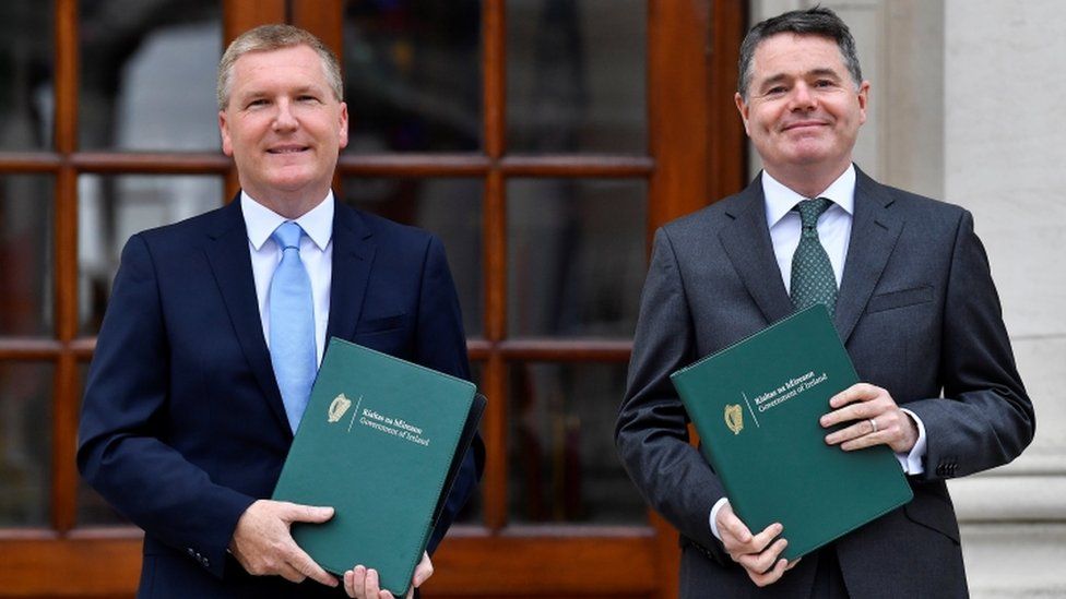 Ireland"s Minister for Finance Paschal Donohoe and Minister for Public Expenditure and Reform Michael McGrath hold the Budget 2022 documents